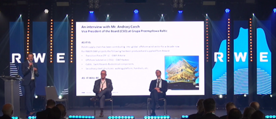 A presentation event featuring Mr. Anthony Catch, Vice President of RWE, with a large screen displaying information behind him.